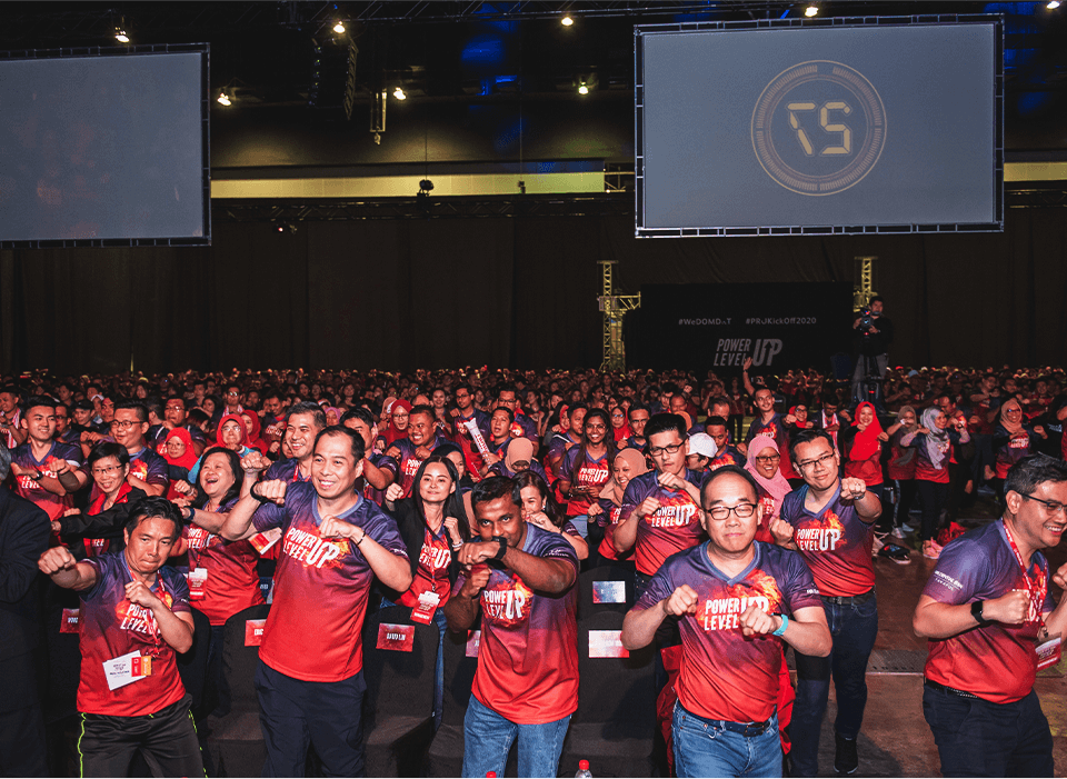 Audience engaging at a corporate conference with keynote speakers for business events on the main stage.
