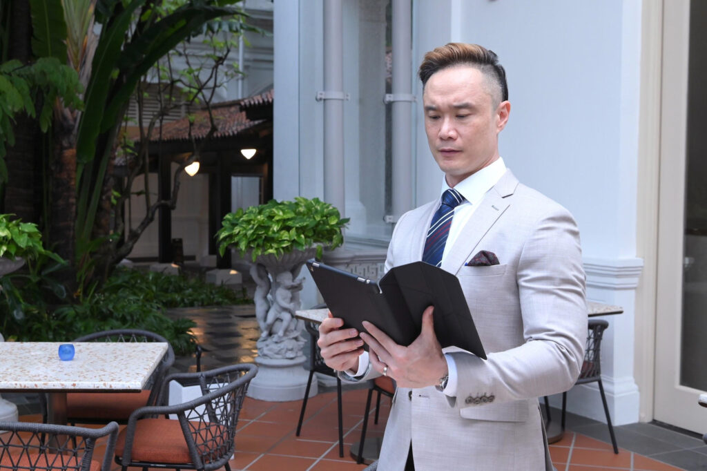 Corporate mental health consultant reviewing a workshop plan on a tablet before an outdoor session.