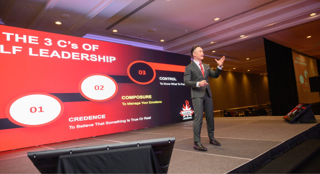 Corporate mental health workshop speaker presenting the 3 C’s of self-leadership on stage